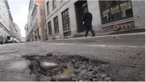 Pothole menace angers motorists, creates business for repair shops